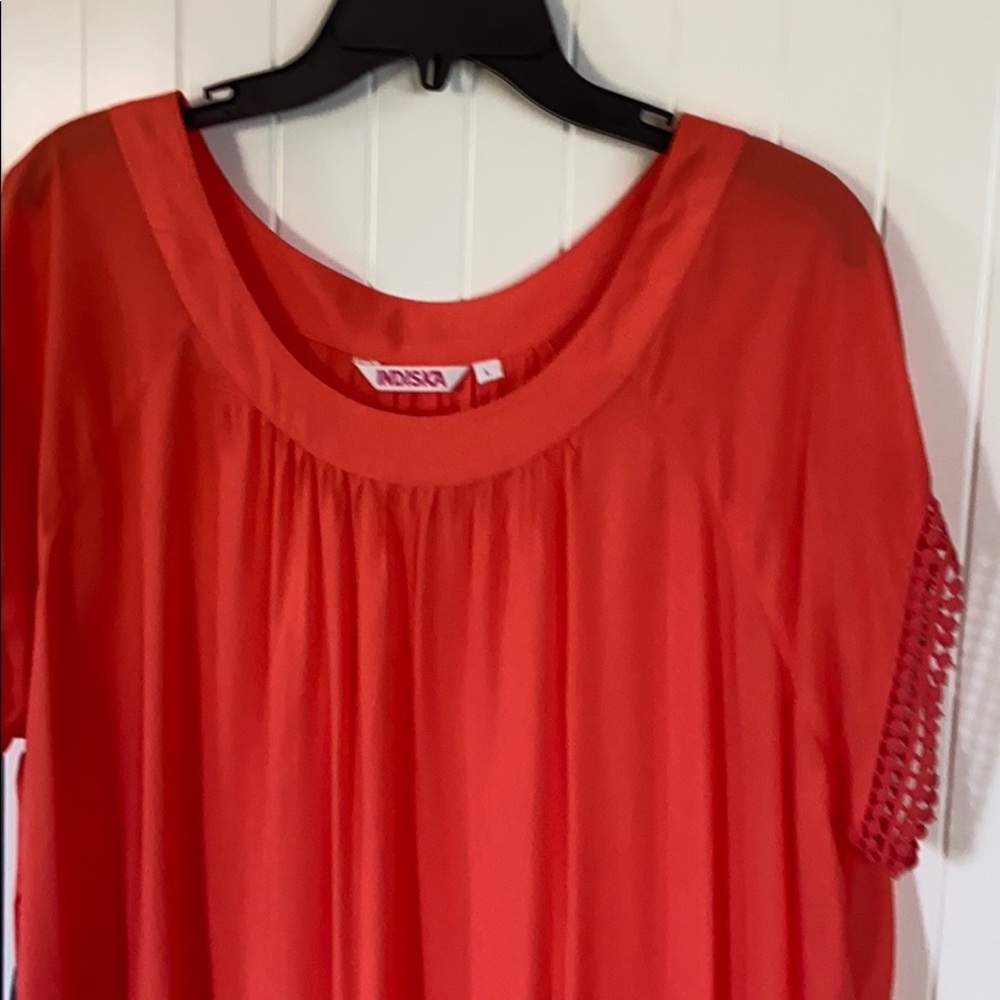 Orange tunic with crochet lace trims. Size L.
